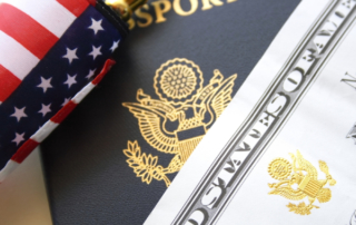 US passport and flag over a citizenship and naturalization certificate